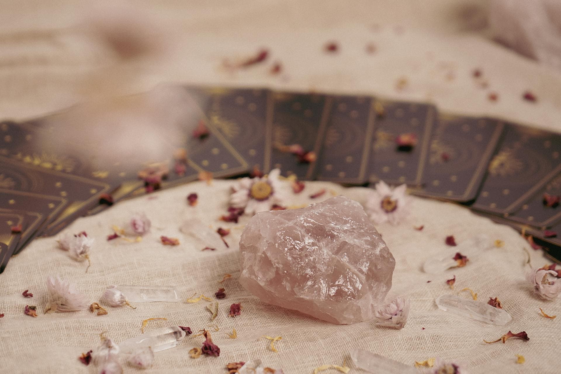 Close-up of a tarot spread with crystals