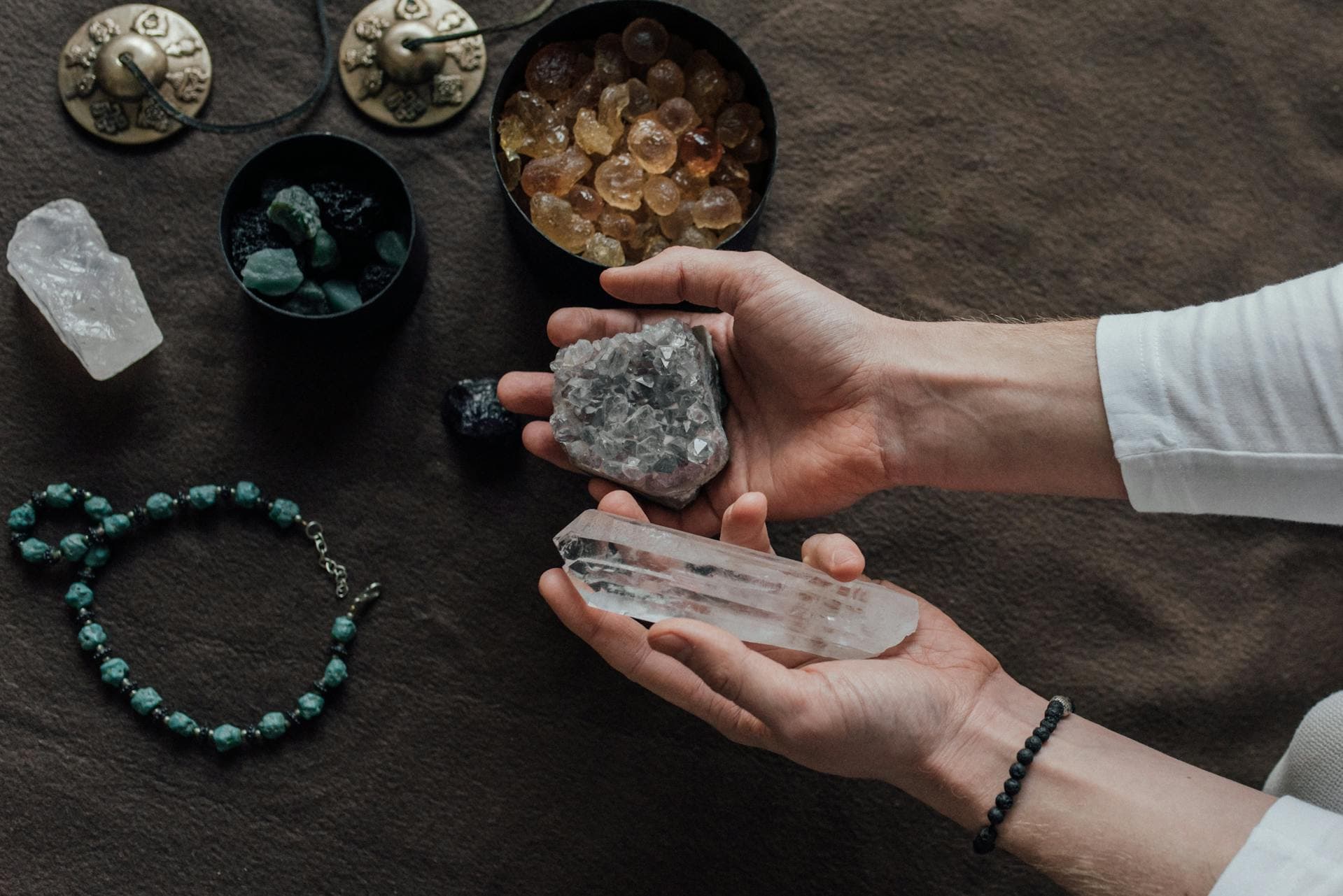 A person holding crystals in their hands.