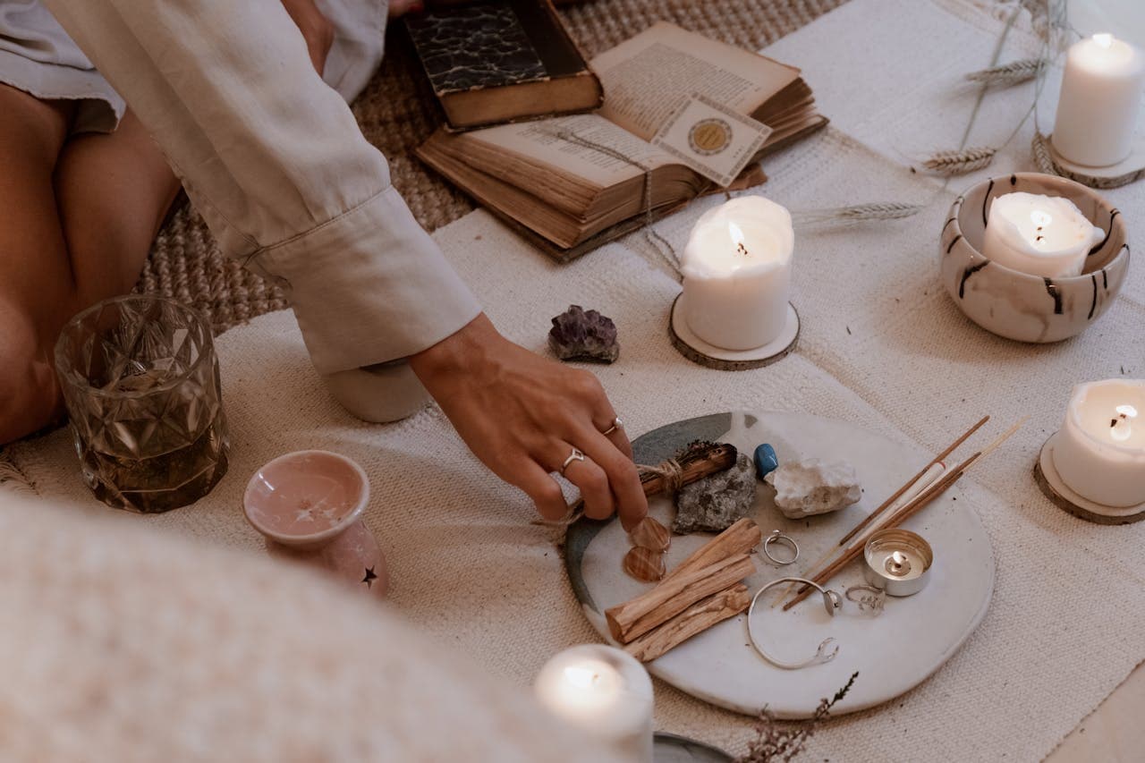 Soft candlelight and hands resting on a table during a reading