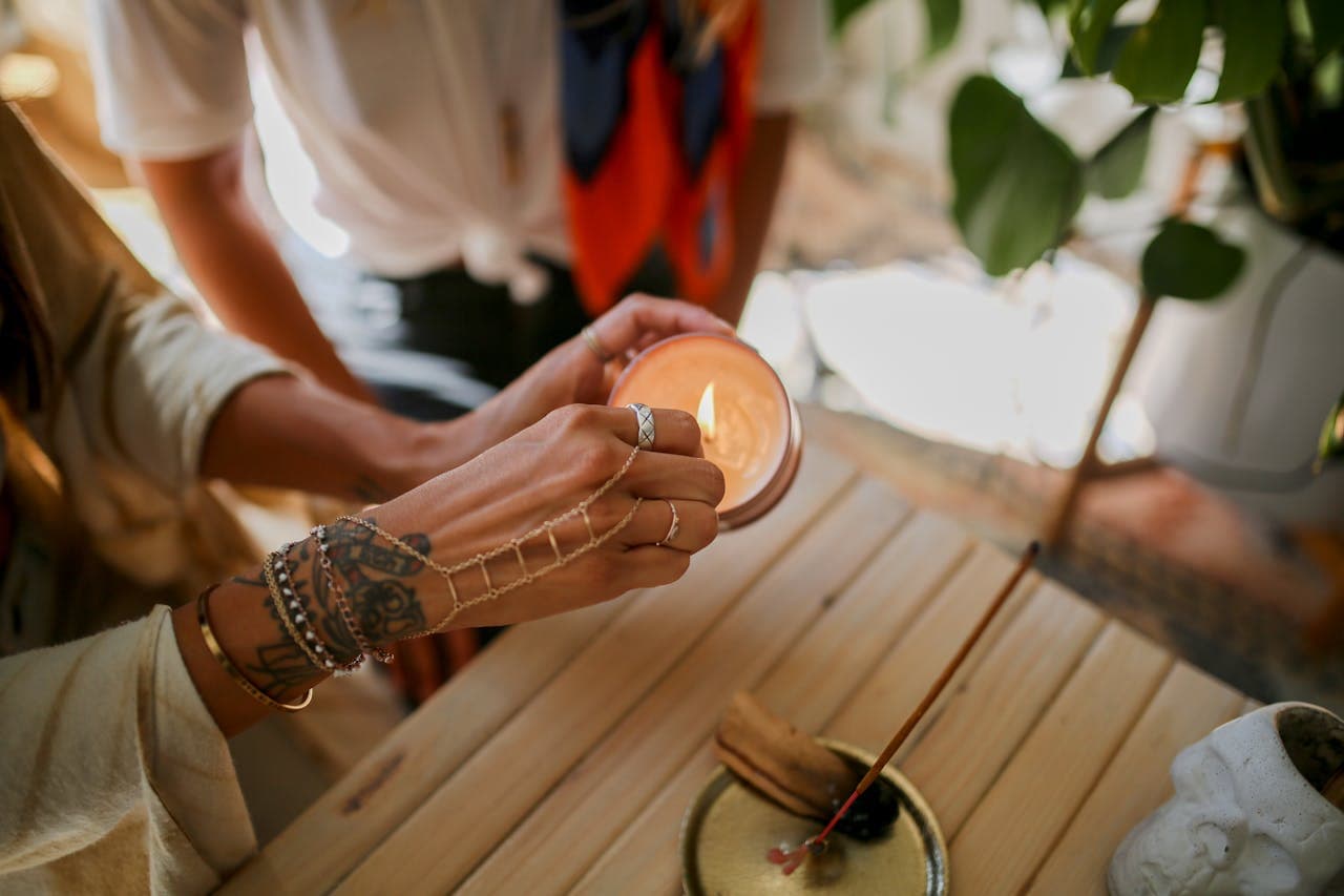 Soft candlelight and hands resting on a table during a reading